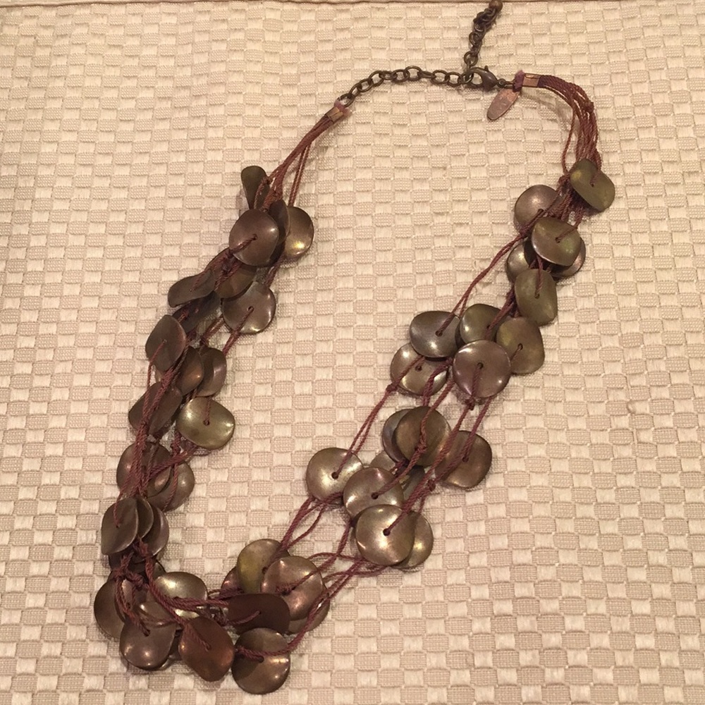 Necklace with brown metal circles together with thick string. From NY and Co.